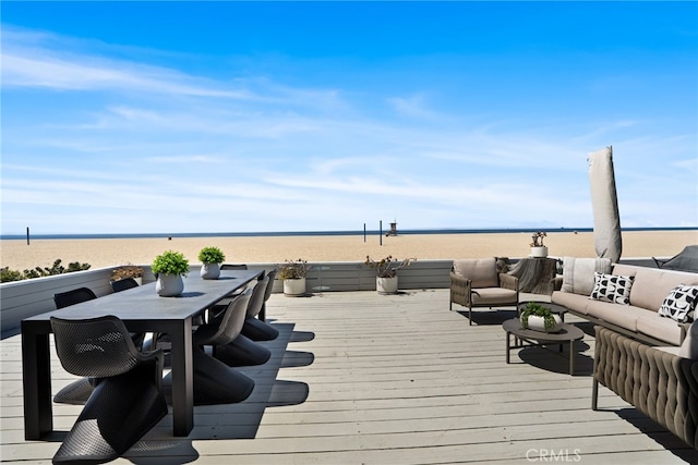deck with a water view, an outdoor living space, and outdoor dining area