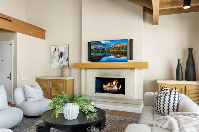 living room featuring a high end fireplace and wood finished floors