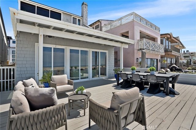 wooden terrace featuring an outdoor hangout area and outdoor dining area