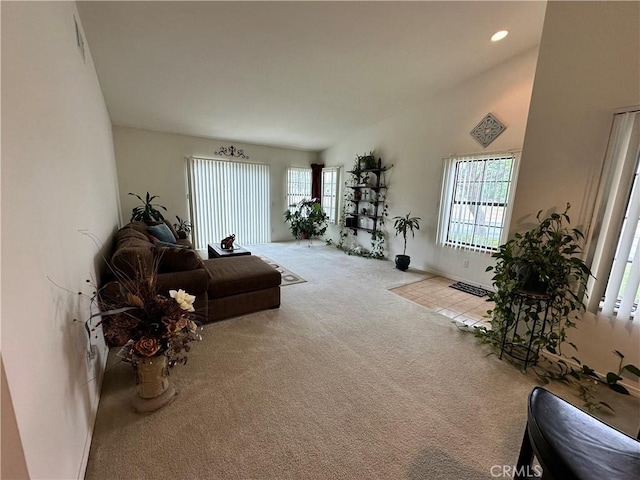 carpeted living area featuring recessed lighting and visible vents