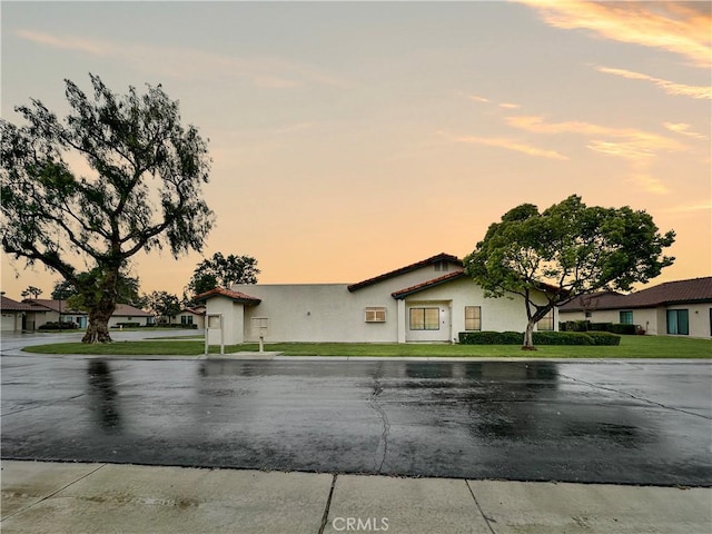 view of front of home with a front lawn and stucco siding