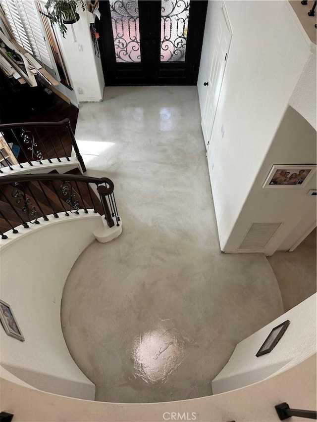 interior details featuring french doors and finished concrete floors