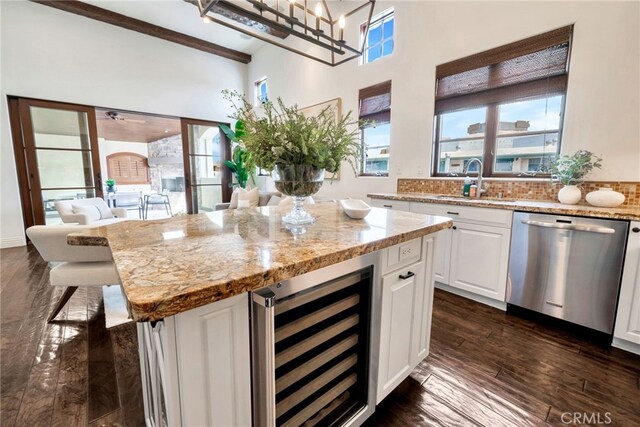 4301/2 Heliotrope Ave, Corona Del Mar, CA 92625 - kitchen featuring stainless steel dishwasher, white cabinets, light stone countertops, and wine cooler