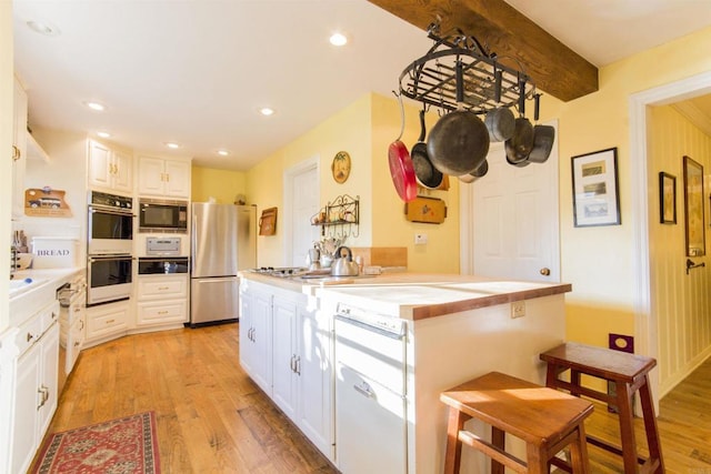 28831 Spruce Rd, Pine Valley, CA 91962 - kitchen with appliances with stainless steel finishes, light wood finished floors, white cabinetry, and recessed lighting