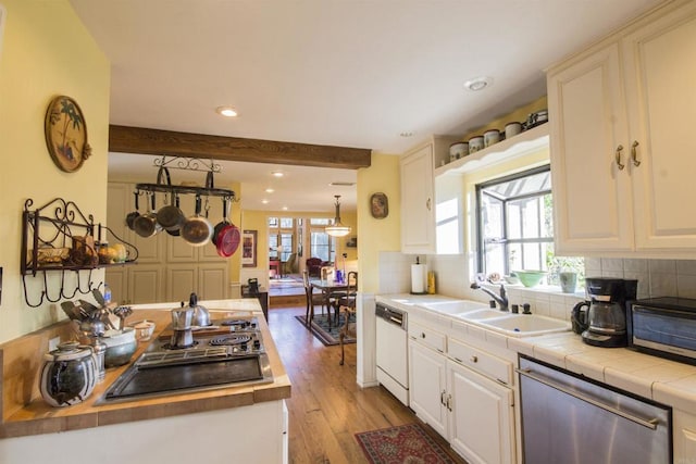 28831 Spruce Rd, Pine Valley, CA 91962 - kitchen with stainless steel dishwasher, black electric cooktop, healthy amount of natural light, light wood-style flooring, and beamed ceiling