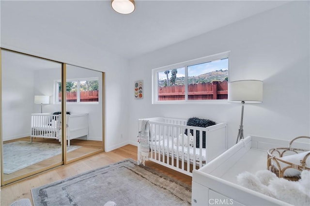 8 Clipper Rd, Rancho Palos Verdes, CA 90275 - bedroom with a closet, a nursery area, wood finished floors, and baseboards
