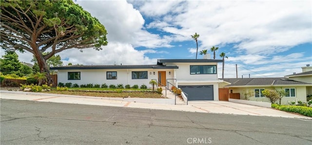 8 Clipper Rd, Rancho Palos Verdes, CA 90275 - tri-level home featuring stucco siding, concrete driveway, and an attached garage
