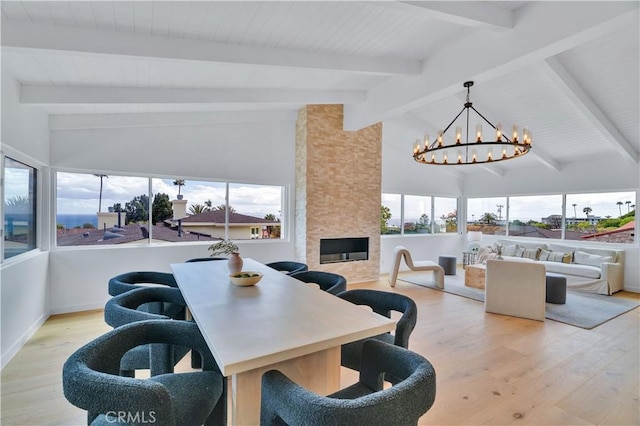 8 Clipper Rd, Rancho Palos Verdes, CA 90275 - dining space with wood finished floors, an inviting chandelier, beamed ceiling, a large fireplace, and baseboards
