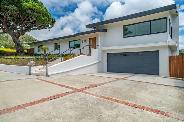 8 Clipper Rd, Rancho Palos Verdes, CA 90275 - view of front of property featuring driveway, a garage, stucco siding, and fence