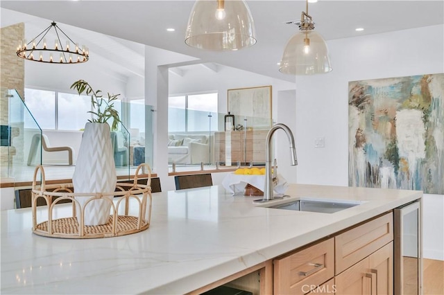 8 Clipper Rd, Rancho Palos Verdes, CA 90275 - kitchen with an inviting chandelier, hanging light fixtures, light stone counters, a sink, and lofted ceiling