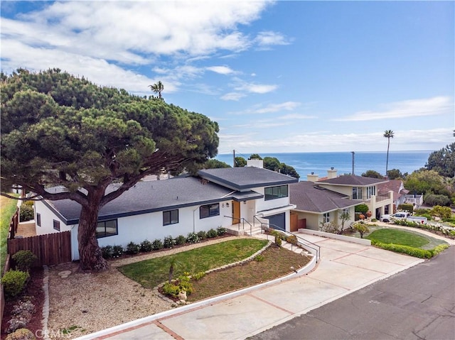 8 Clipper Rd, Rancho Palos Verdes, CA 90275 - view of front of house featuring fence, a water view, driveway, roof with shingles, and a front lawn