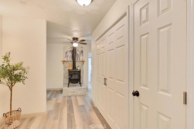 hallway with light wood finished floors and baseboards