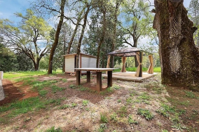 view of yard featuring an outdoor structure, a shed, and a gazebo
