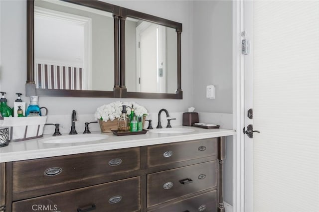 full bath featuring double vanity and a sink