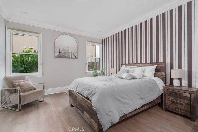 bedroom with baseboards, ornamental molding, wallpapered walls, and wood finished floors
