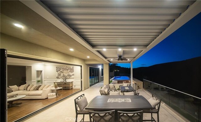 balcony at twilight featuring a ceiling fan and outdoor dining space