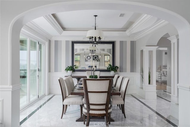 dining area with wainscoting, a decorative wall, arched walkways, marble finish floor, and visible vents