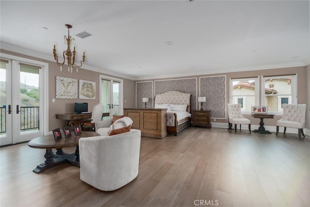 bedroom with french doors, visible vents, crown molding, light wood-style floors, and access to outside