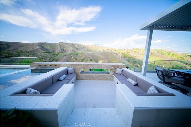 view of patio / terrace with an outdoor hangout area and a mountain view