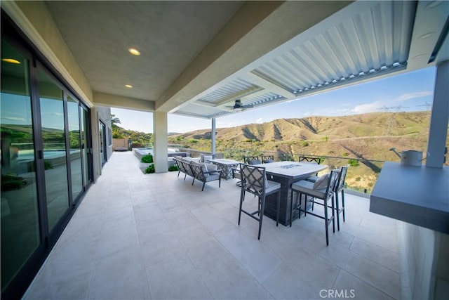 view of patio / terrace featuring outdoor lounge area, a mountain view, and outdoor dining space