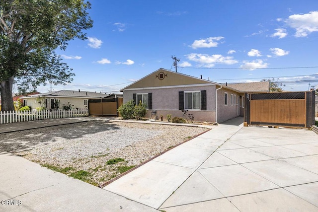 ranch-style house with fence and stucco siding
