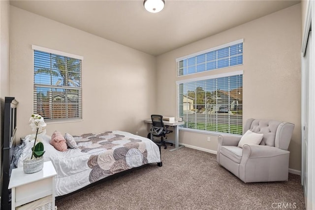 carpeted bedroom with baseboards