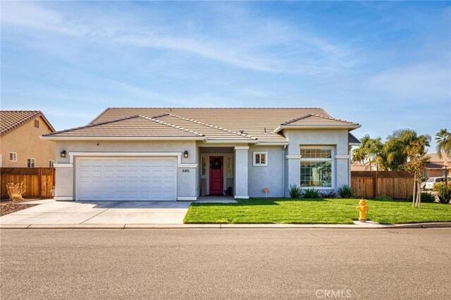 ranch-style house with a front yard, stucco siding, concrete driveway, an attached garage, and fence