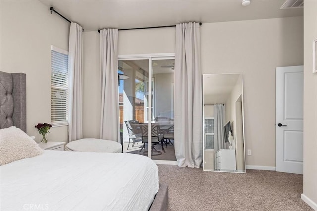 carpeted bedroom with baseboards, visible vents, and access to outside