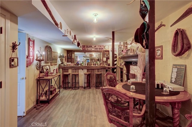 dining room featuring a bar and wood finished floors
