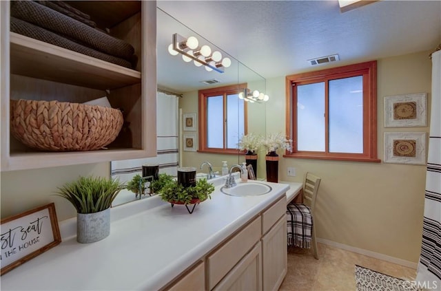 bathroom featuring visible vents, a chandelier, vanity, and baseboards