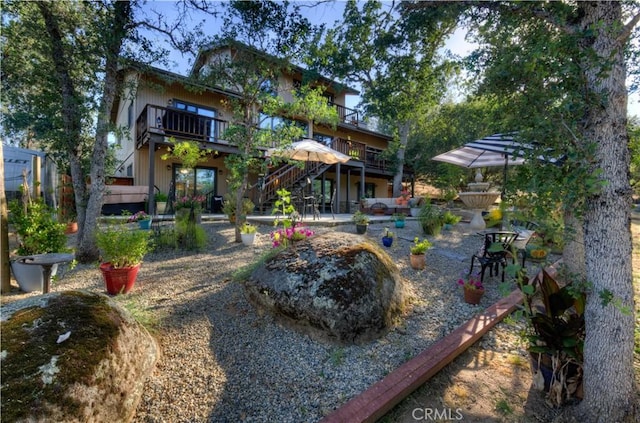 view of yard with a wooden deck, a patio area, and stairs
