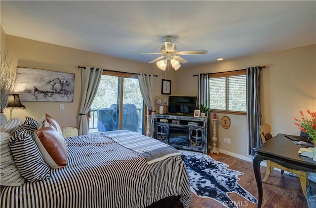 bedroom featuring wood finished floors, ceiling fan, baseboards, and multiple windows
