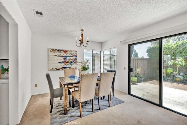 1021 Carmel Cir, Fullerton, CA 92833 - dining space featuring visible vents, a textured ceiling, a notable chandelier, and light carpet