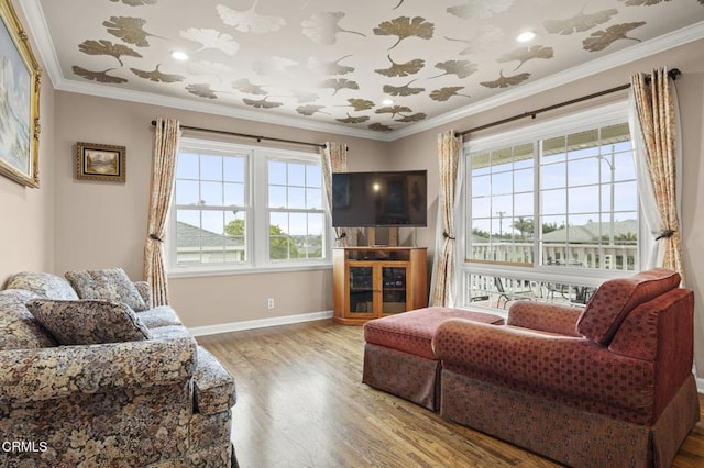 living room featuring ornamental molding, plenty of natural light, and wood finished floors