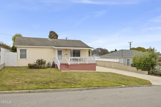 bungalow-style house with a front yard, driveway, and fence private yard