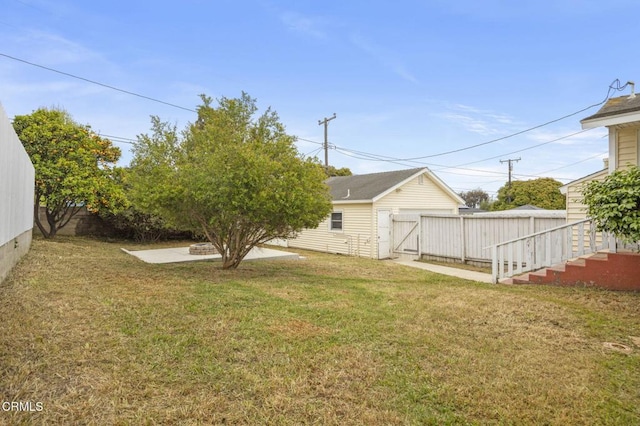 view of yard featuring a patio area, a gate, and a fenced backyard