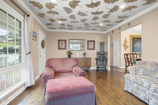 living room with crown molding, baseboards, and wood finished floors