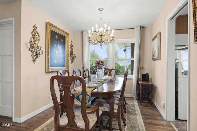 dining space with dark wood-style flooring, baseboards, and a notable chandelier
