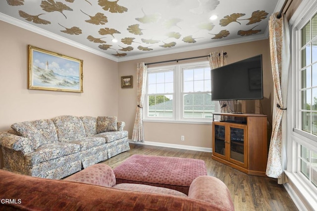 living area with baseboards, crown molding, and wood finished floors