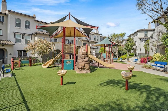 community jungle gym featuring a yard