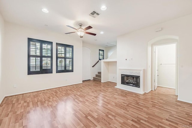 unfurnished living room with visible vents, a ceiling fan, and light wood finished floors