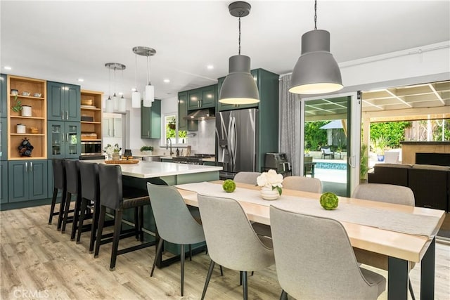 dining space featuring light wood-style floors and recessed lighting