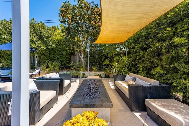 view of patio / terrace with an outdoor living space with a fire pit