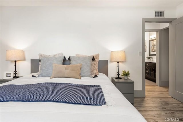 bedroom with visible vents and light wood finished floors