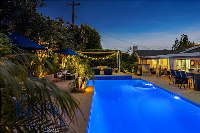 pool with a patio, an outdoor living space, and outdoor dining area