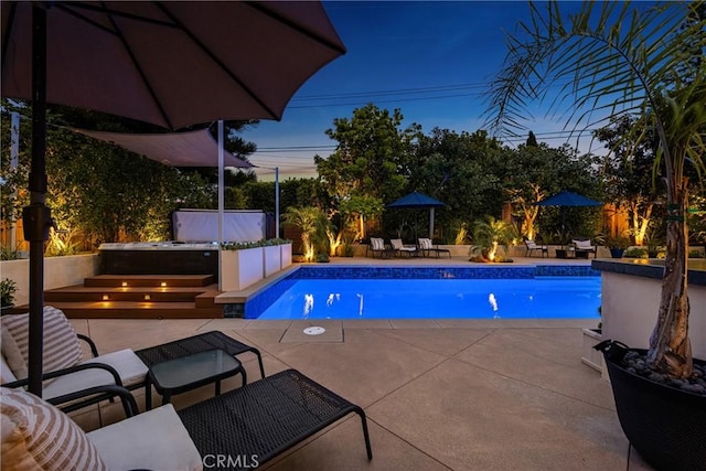 pool featuring a jacuzzi and a patio area
