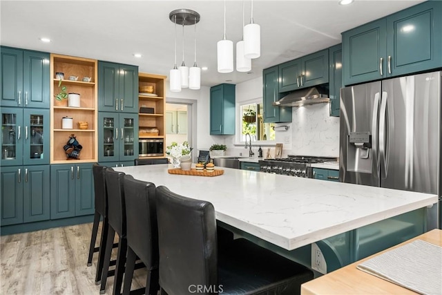 kitchen with open shelves, under cabinet range hood, light wood finished floors, stove, and stainless steel fridge with ice dispenser