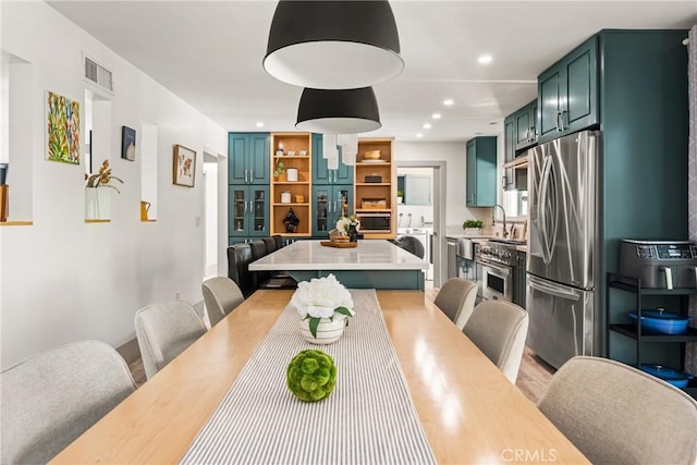 dining area with recessed lighting, light wood finished floors, visible vents, and washer / clothes dryer