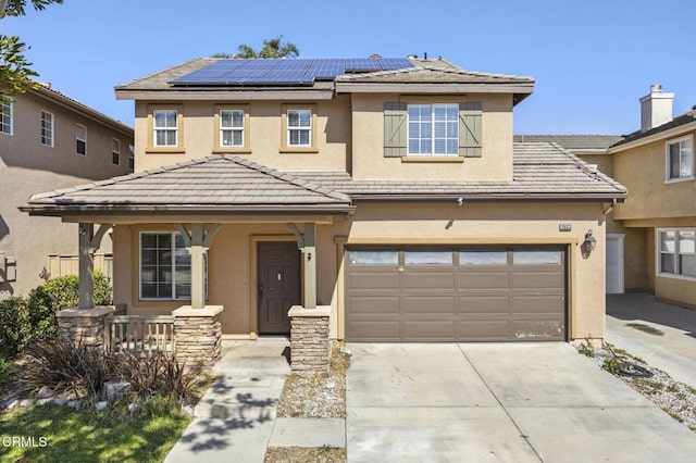 traditional-style house featuring a tile roof, stucco siding, a porch, concrete driveway, and solar panels