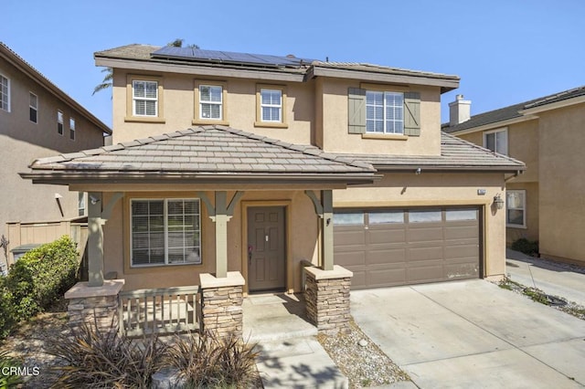 traditional-style home with a porch, concrete driveway, solar panels, and stucco siding